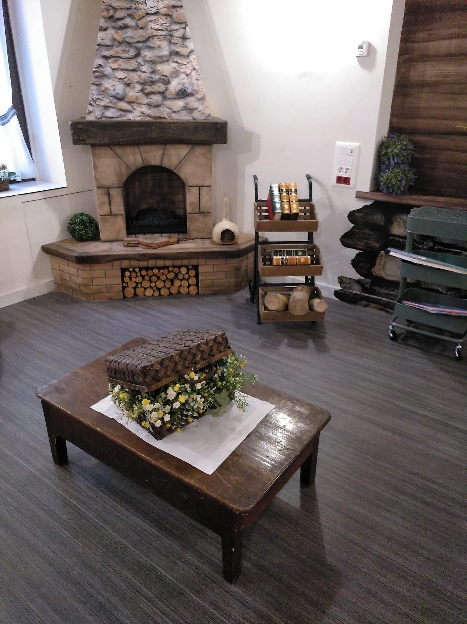 Una sala de estar con chimenea y una mesa de madera.