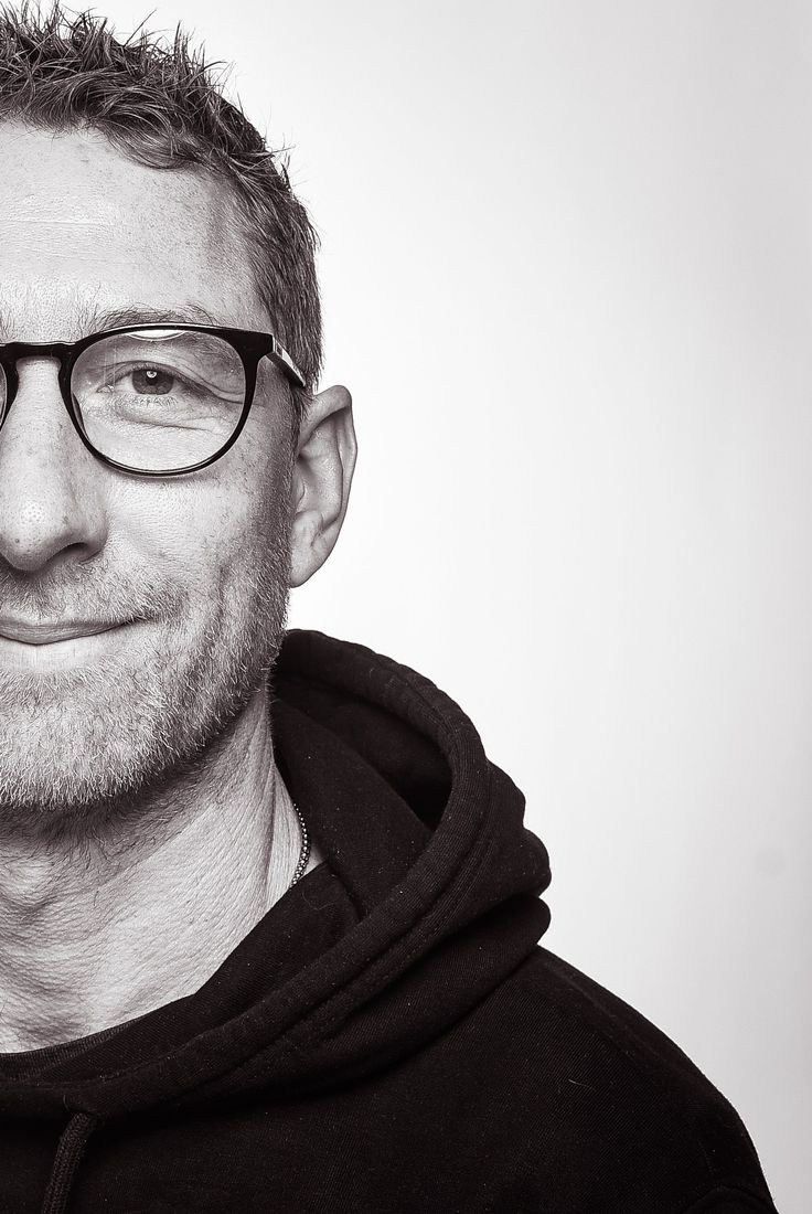 Ein Mann (Henning Pelant) mit Brille und Bart trägt einen schwarzen Kapuzenpullover