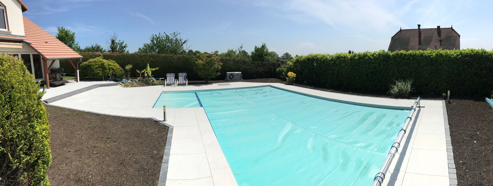 Piscine avec bâche installée pour la protéger.