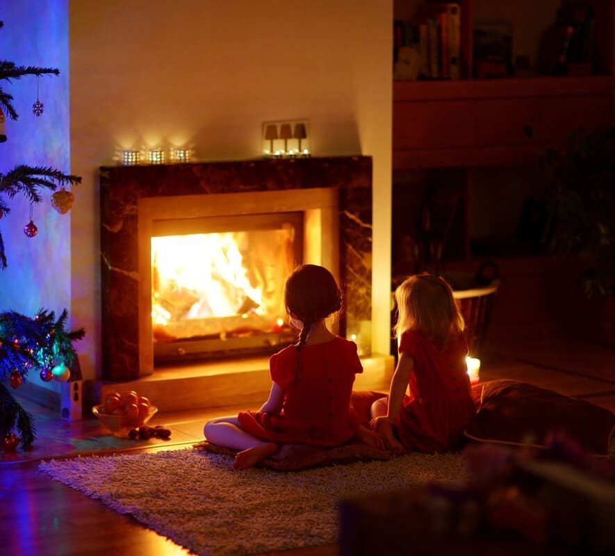 enfants regardant du bois flambant dans une cheminée