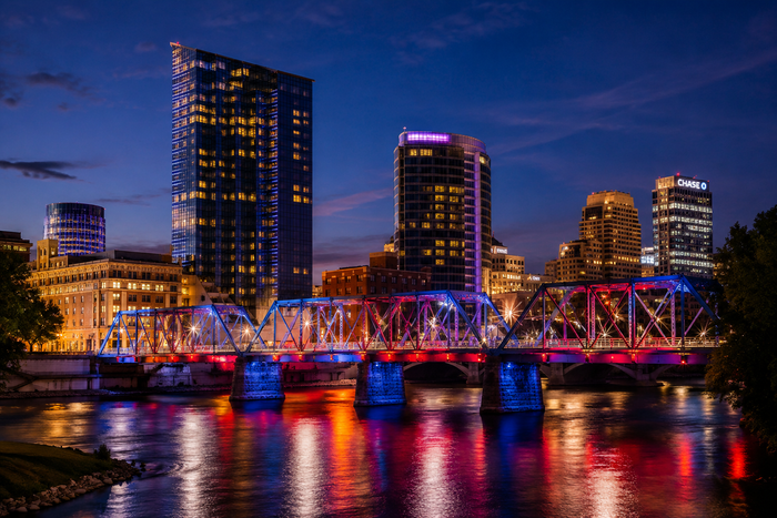 Downtown Grand Rapids skyline and illuminated bridge at night