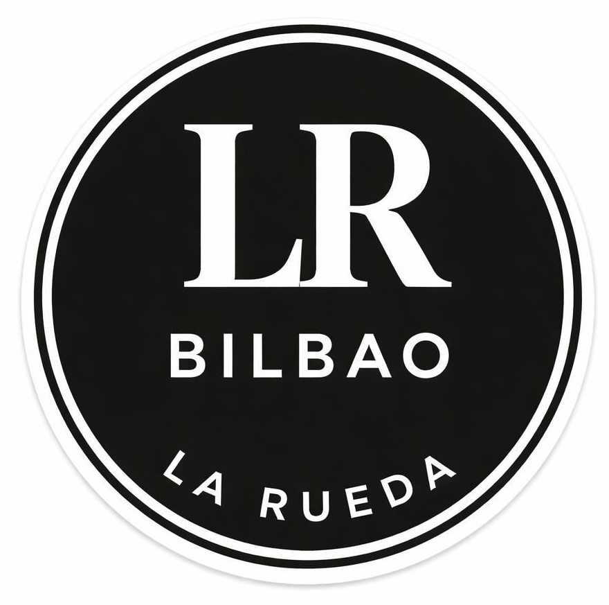 Un logotipo circular con fondo negro y texto blanco. Incluye las palabras "LR", "BILBAO" y "LA RUEDA" en letra blanca.