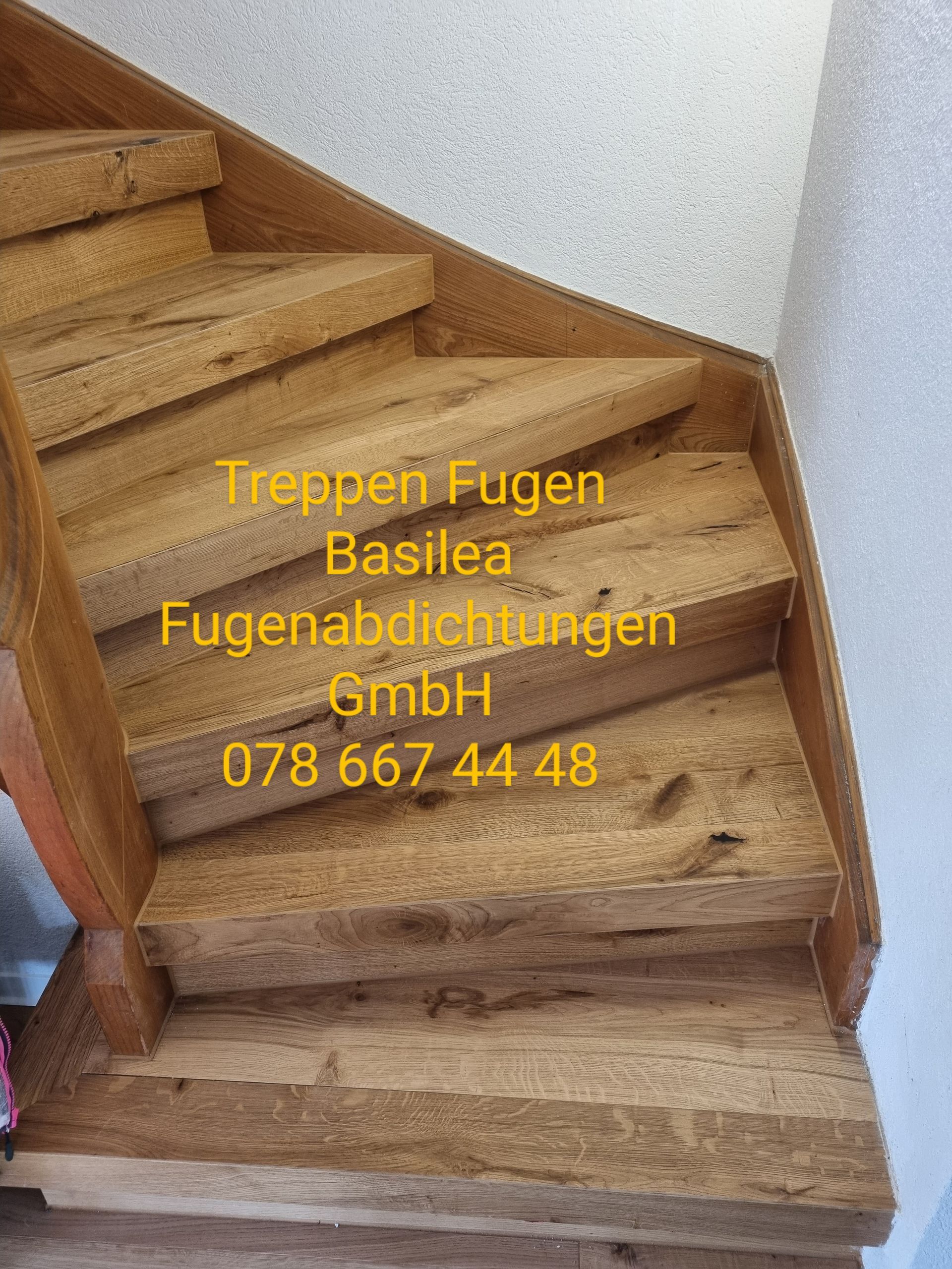 Ein Bild einer Holztreppe mit einer Telefonnummer.