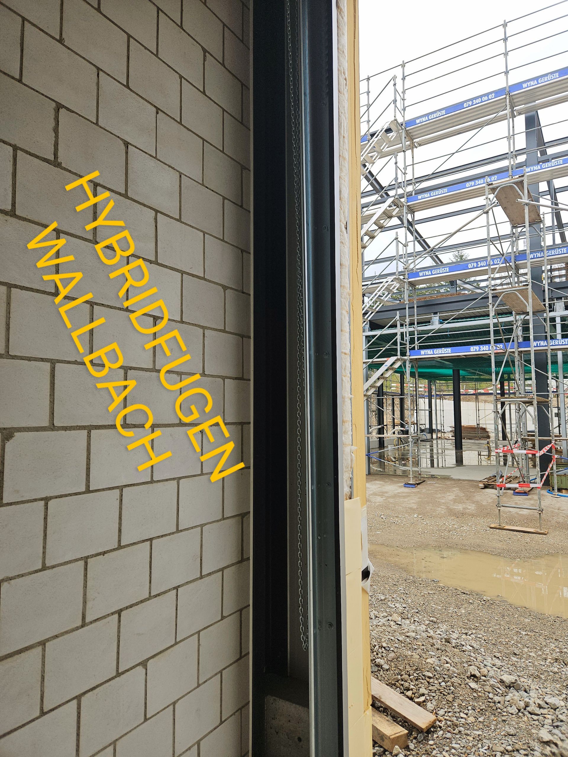 Eine Ziegelwand mit der Aufschrift „Hybrideugen Wallbaox“