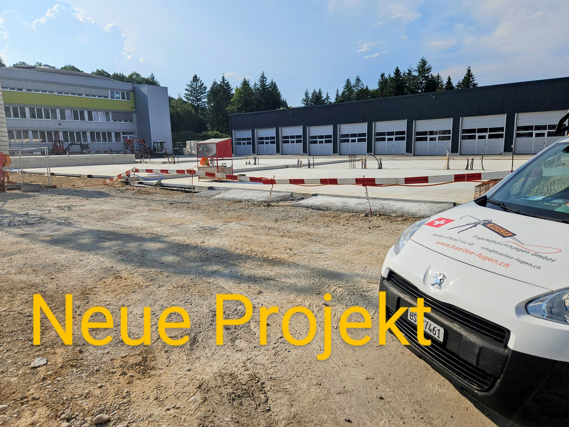 Ein weißer Lieferwagen steht vor einem Gebäude mit der Aufschrift „Neues Projekt“