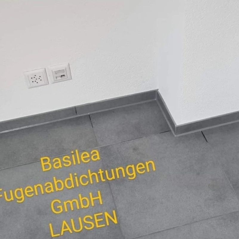 Das Wort Basilea steht auf dem Boden in einem Raum