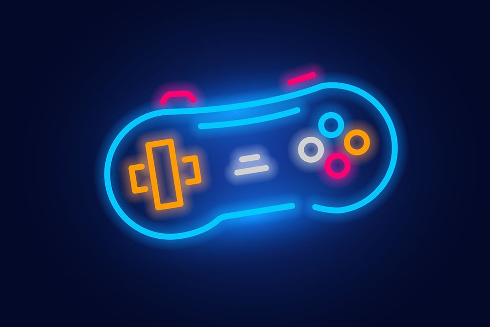 Un letrero de neón de un controlador de videojuego sobre un fondo oscuro.