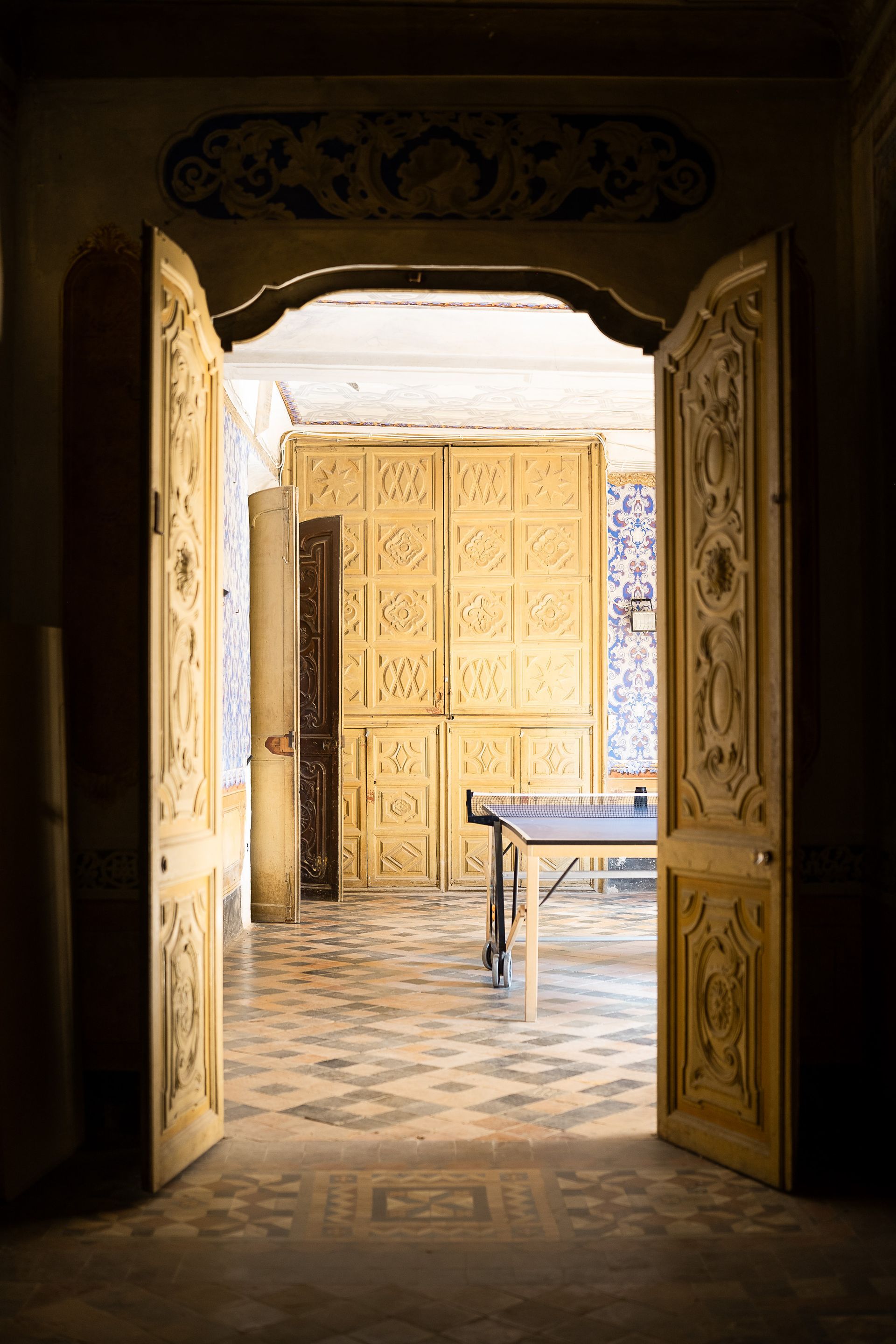 Una habitación con dos puertas abiertas y una mesa dentro.