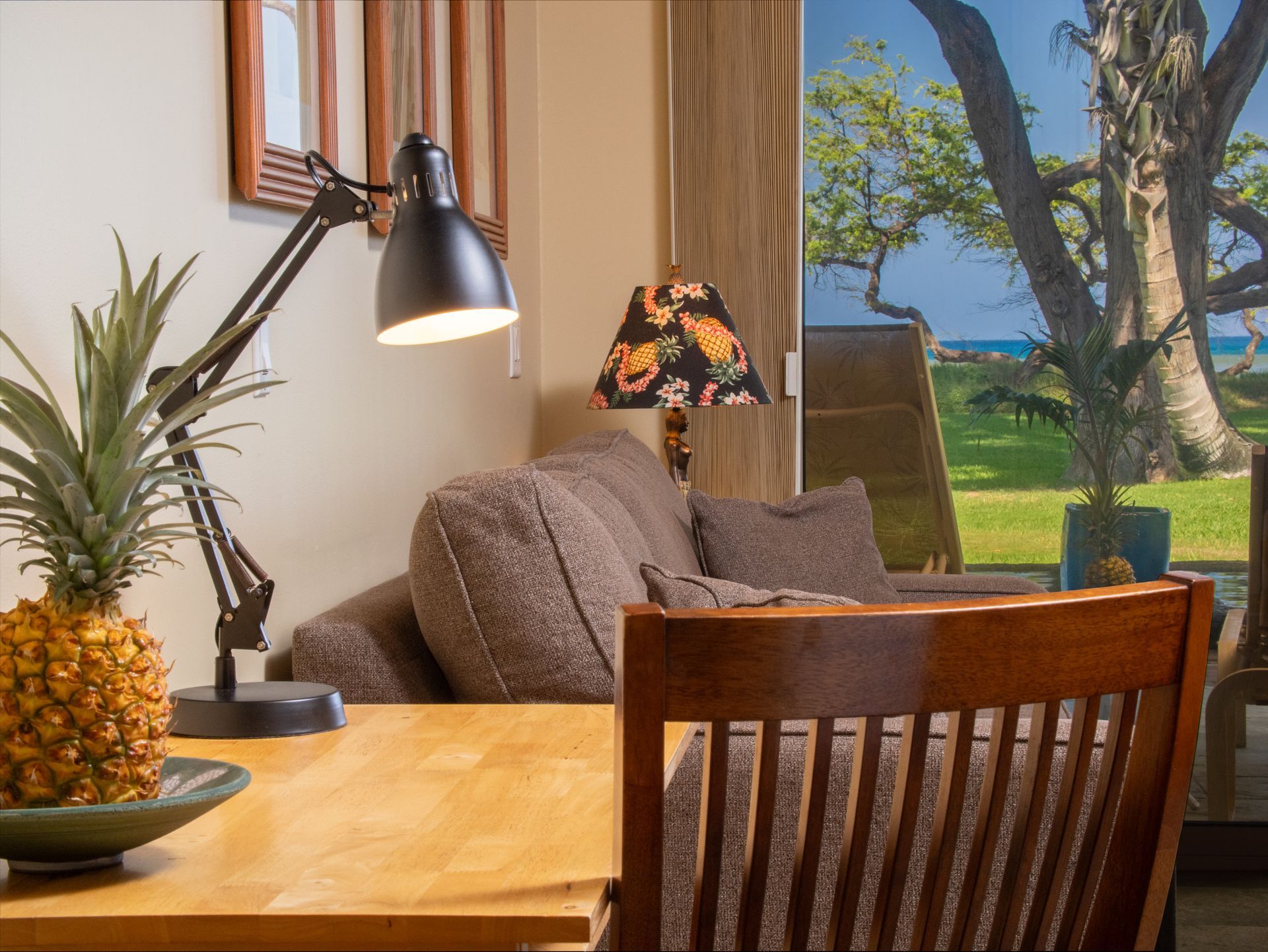 A pineapple sits on a table next to a lamp in a living room