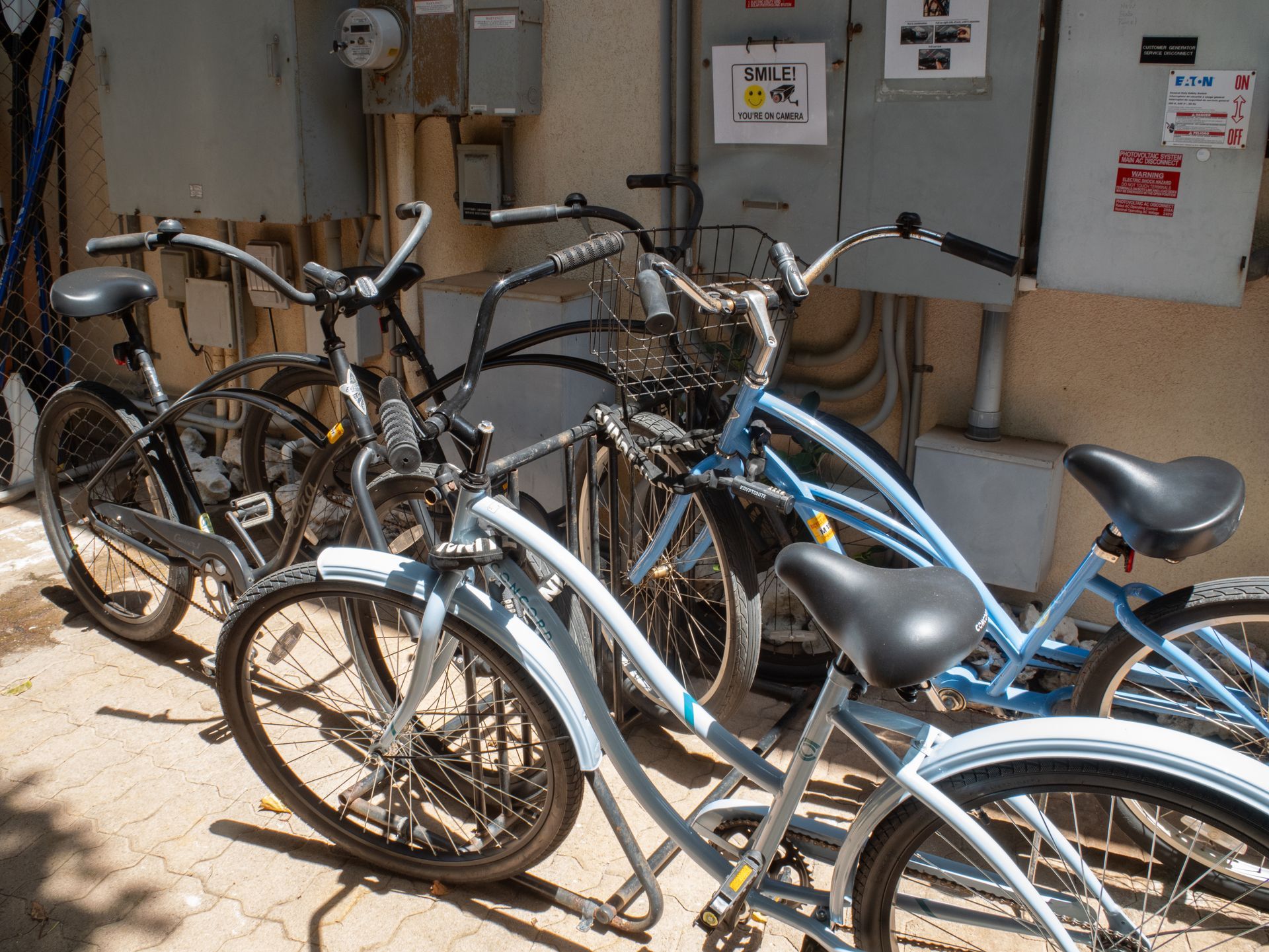 A row of bicycles are parked in front of a building.