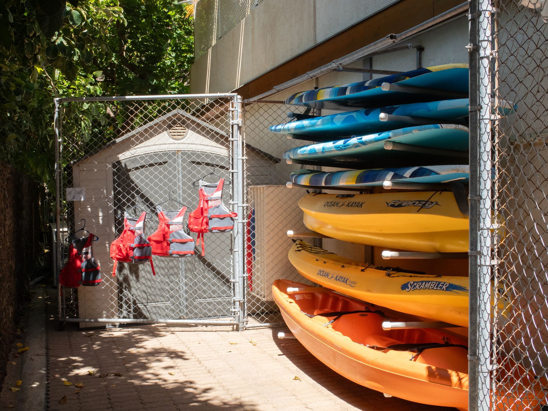 A bunch of kayaks are stacked on top of each other