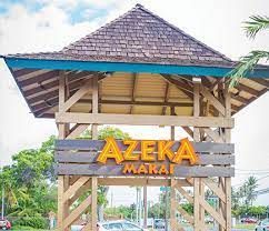 A wooden tower with a sign that says azeka marai on it.