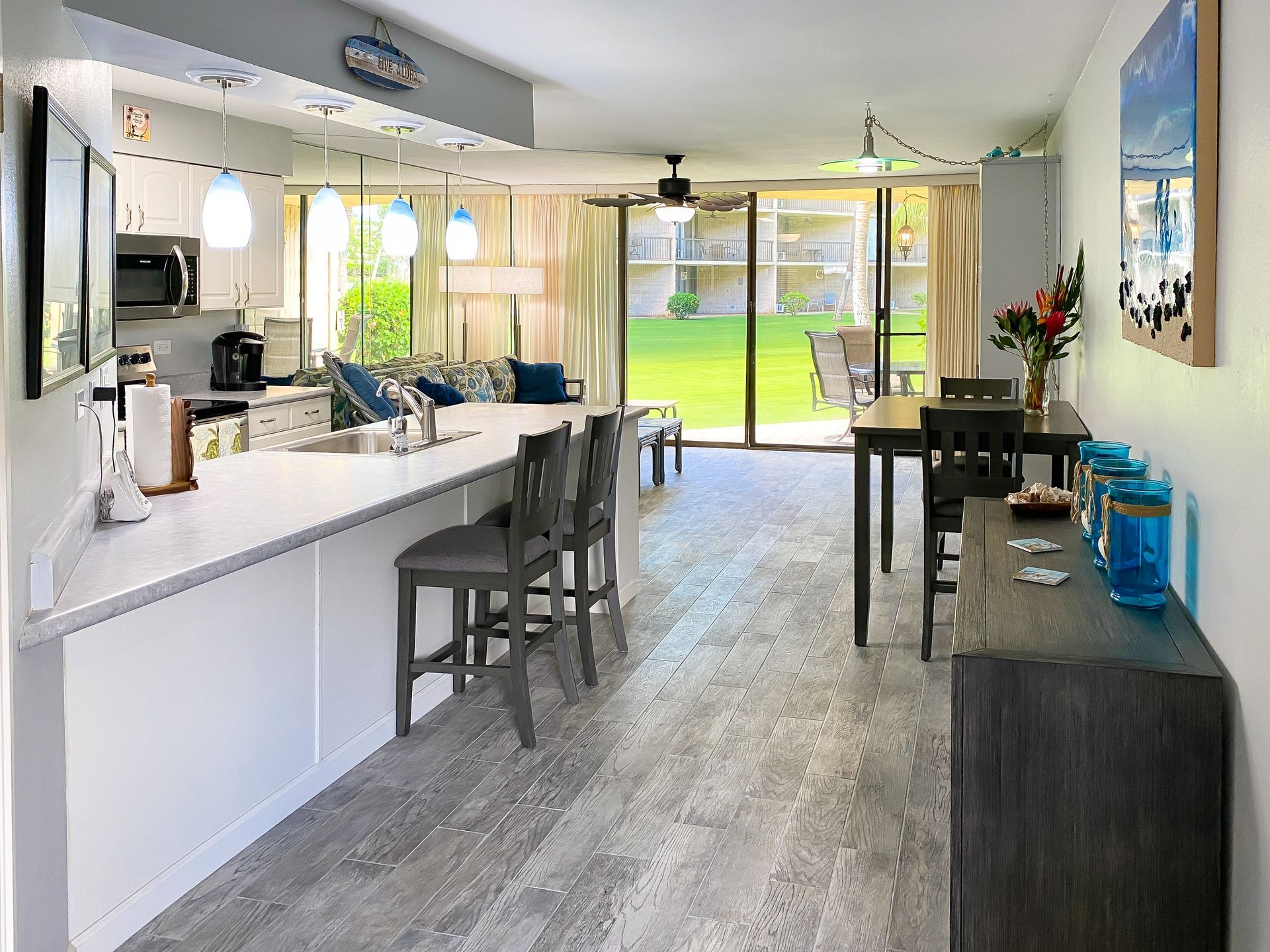 A kitchen and dining room in a house with a table and chairs.