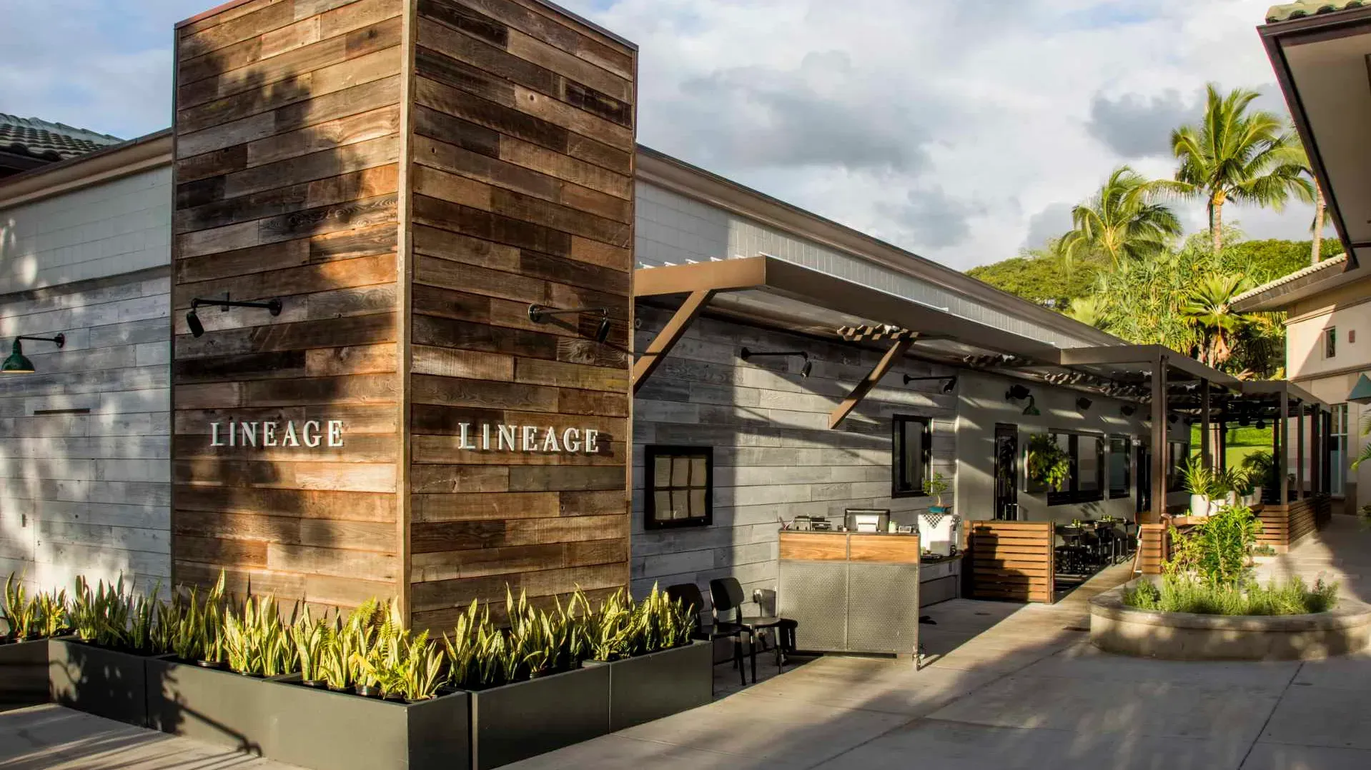 A building with a wooden wall and the word lineage on it.