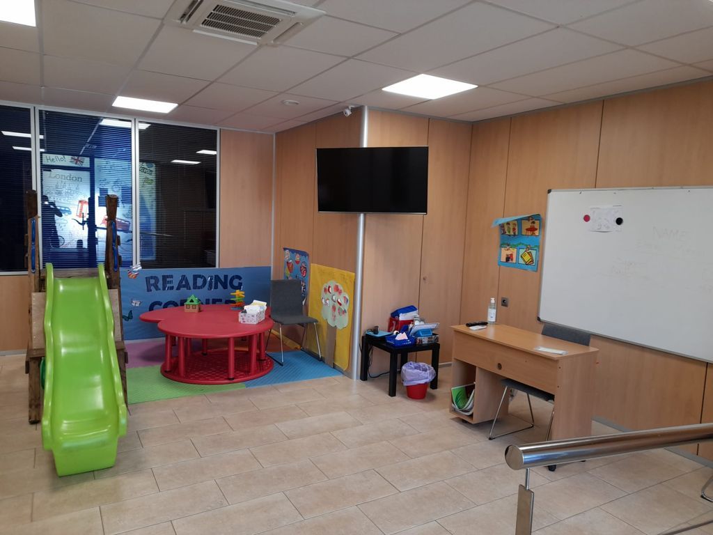 Una habitación con un tobogán y una pizarra que dice leyendo