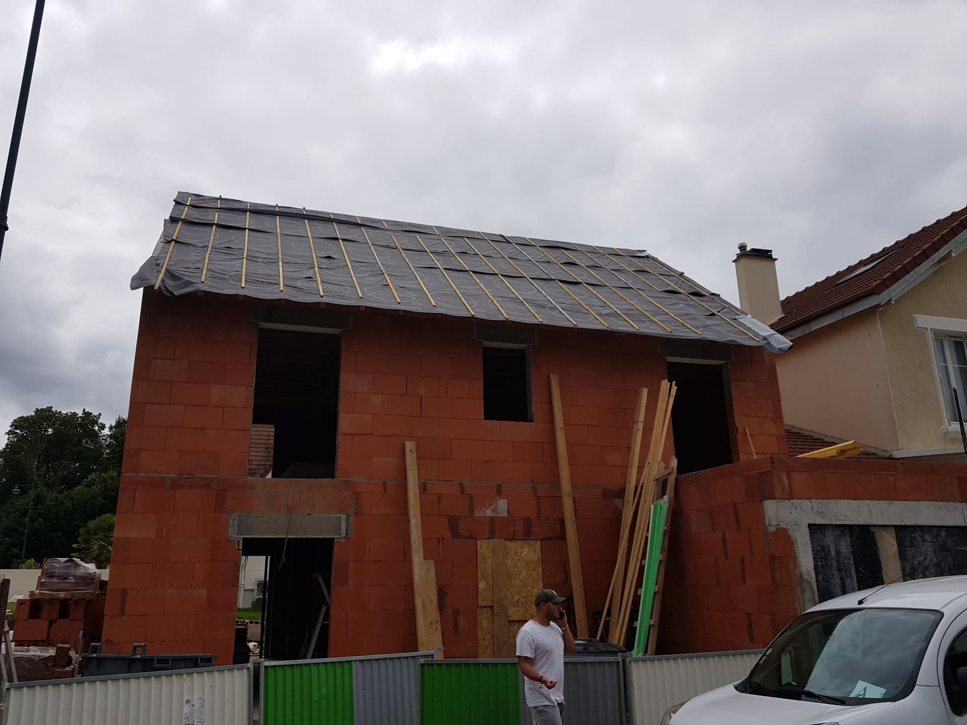 Une maison aux briques rouges en construction.
