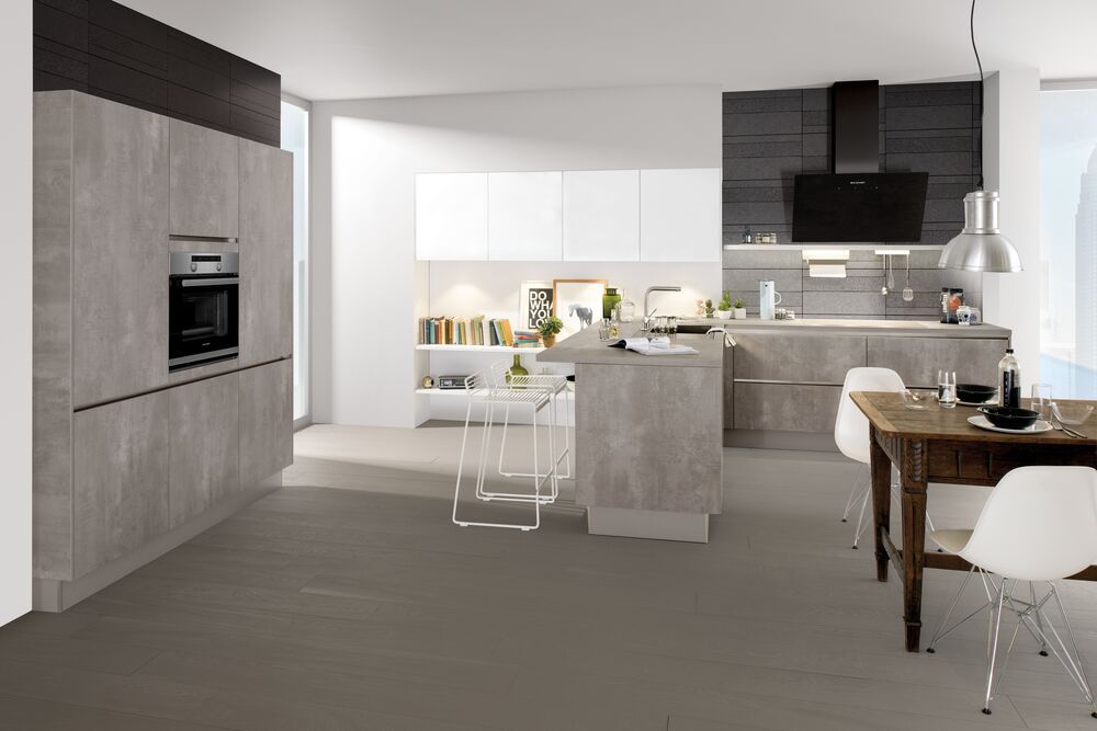 Eine große offene Küche mit einer Theke und Stühlen daneben