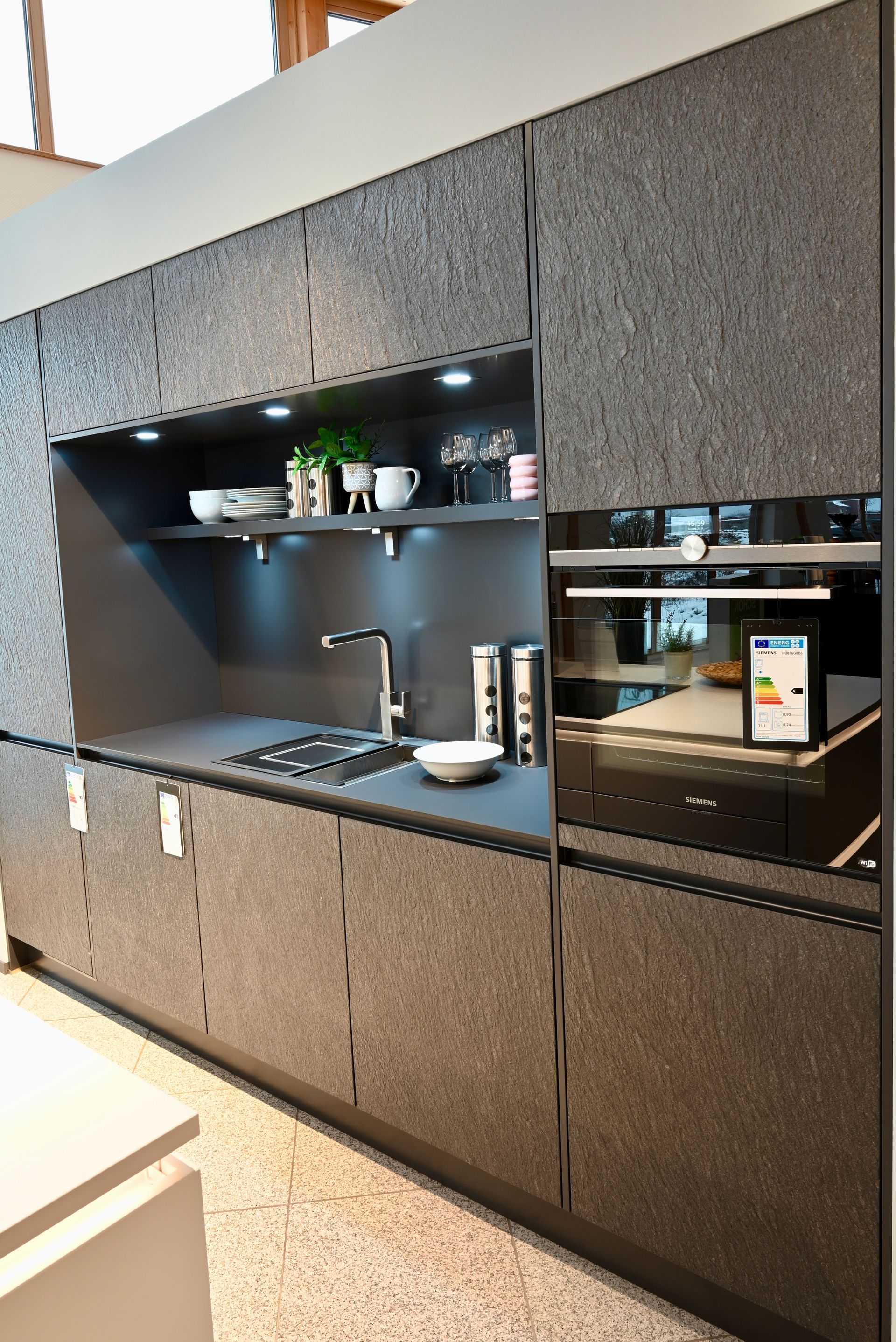 Eine Küche mit Herd, Spüle und Backofen.