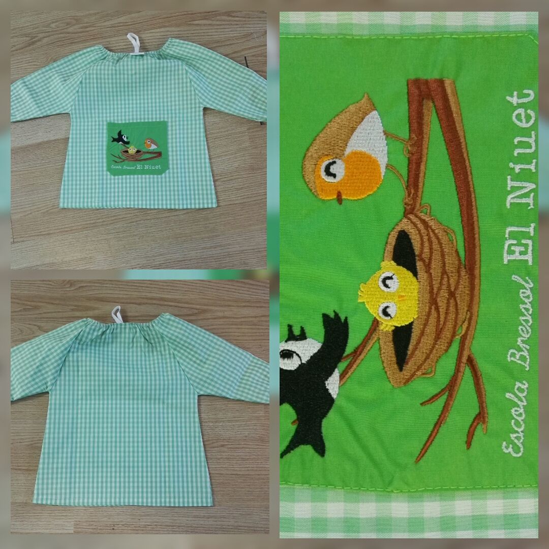 Una camiseta verde con un dibujo de pájaros.