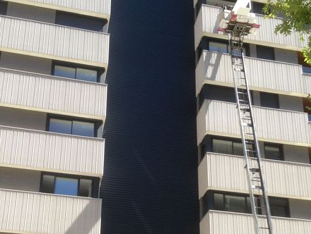 Un camión de mudanzas se eleva contra un edificio para trasladar muebles a un apartamento.