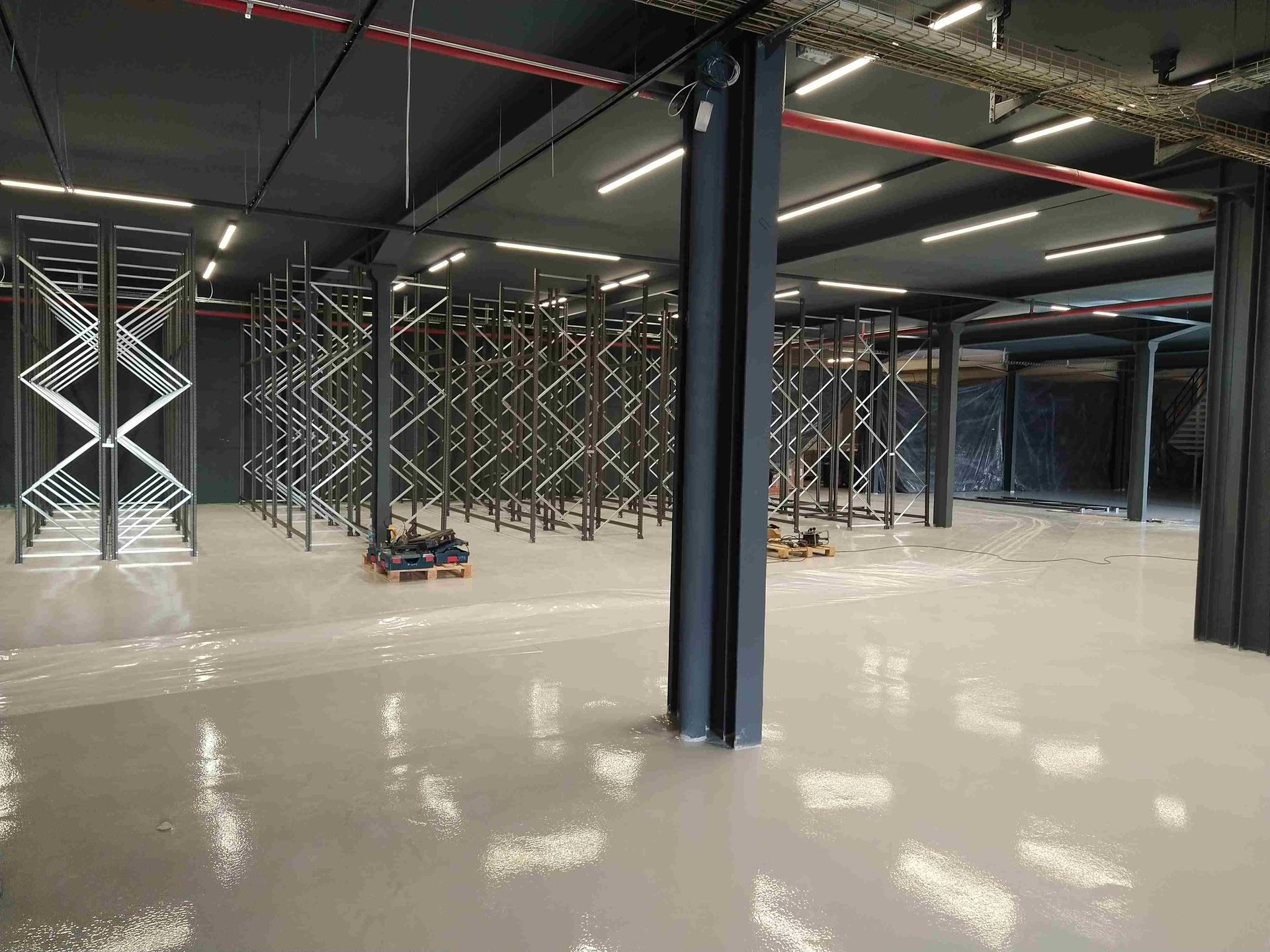 Un gran almacén vacío con muchos estantes y columnas.