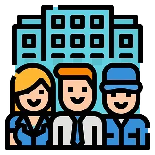 Tres personas sonrientes frente a un edificio de oficinas azul. El grupo incluye una mujer, un hombre de pelo naranja y un hombre con una gorra azul.