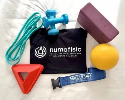 Persona que recibe fisioterapia, terapeuta manipulando rodilla y tobillo.