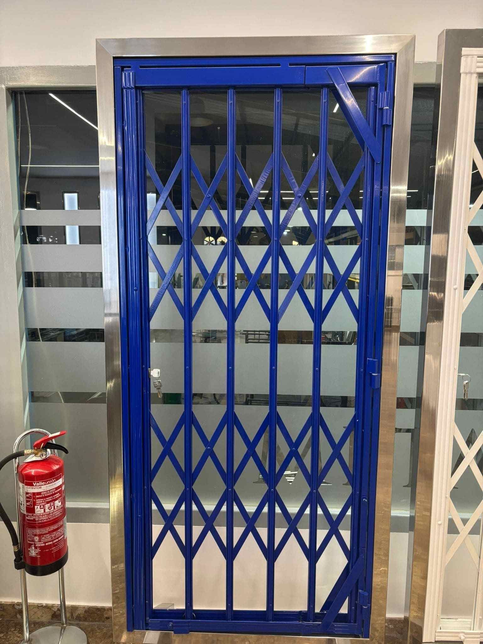 Una puerta azul con un extintor al lado.