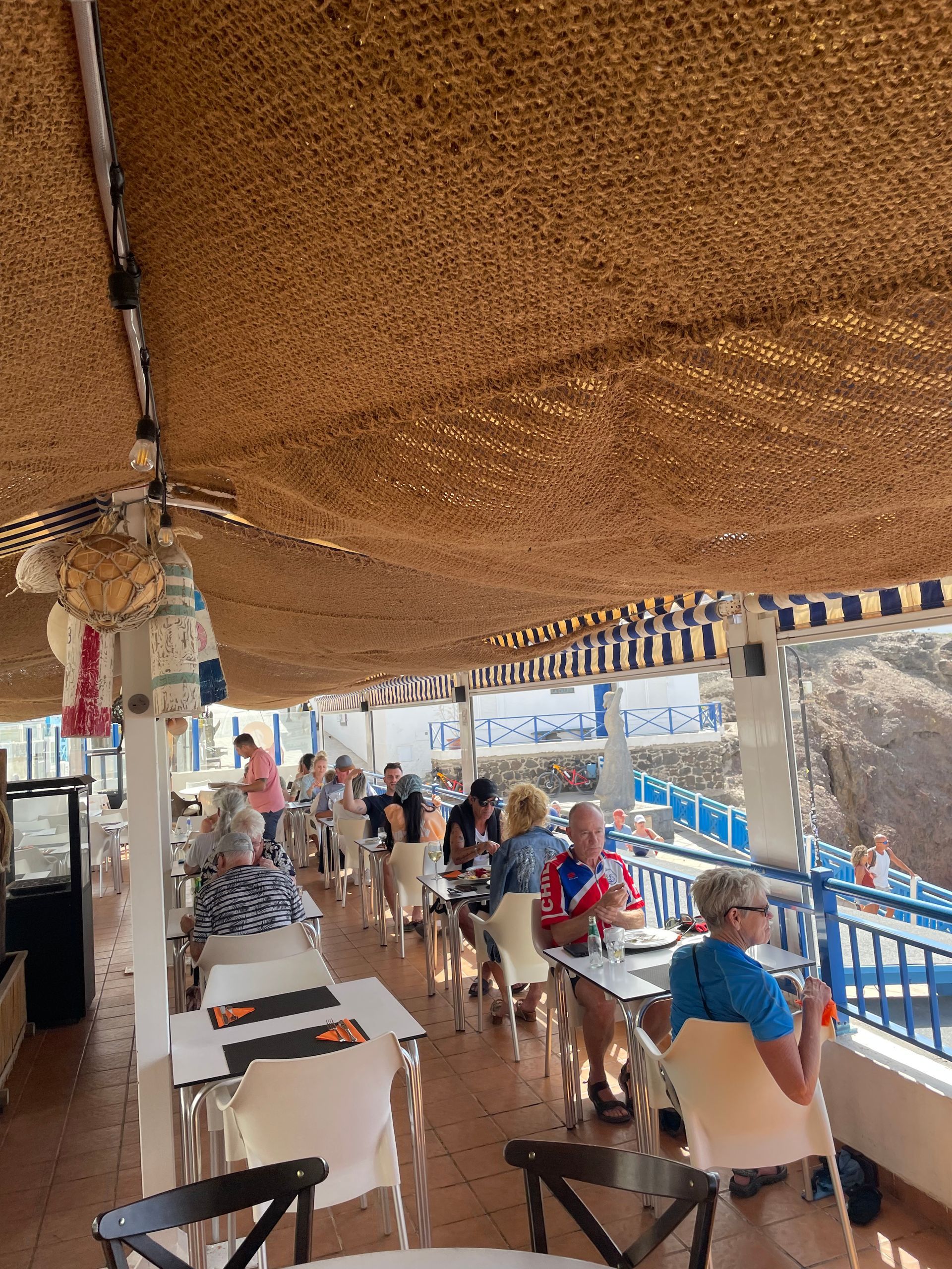 Un grupo de personas están sentadas en mesas en un restaurante.