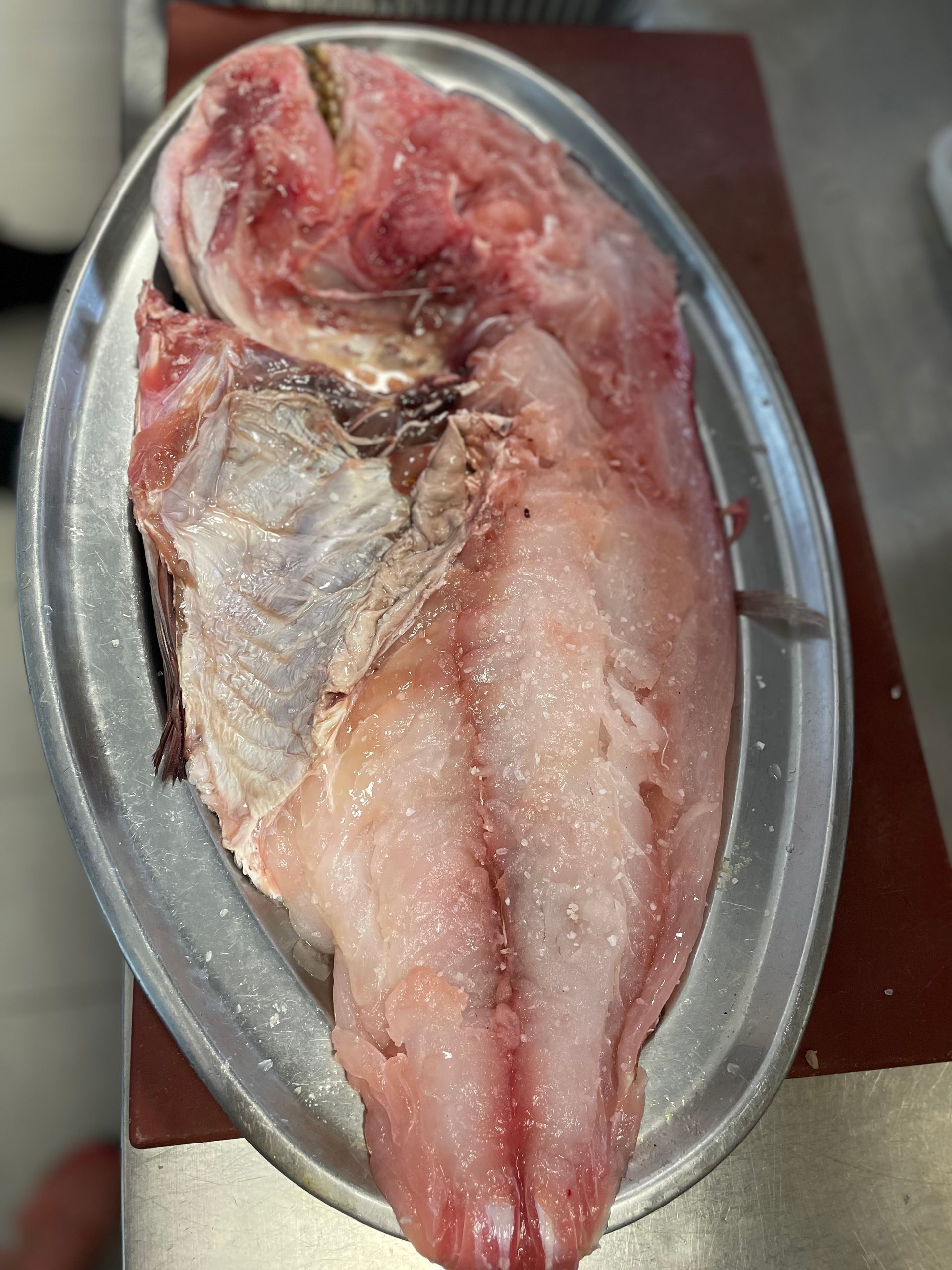 Un primer plano de un trozo de carne en un plato sobre una mesa.