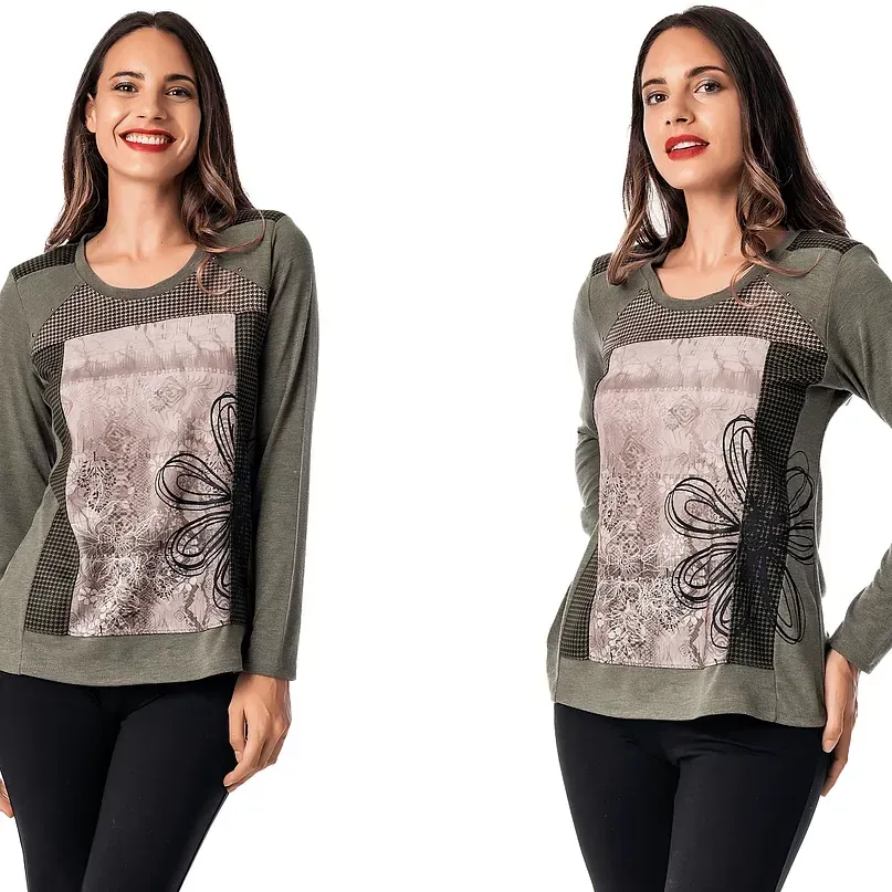 Una mujer lleva una camisa verde con una mariposa.