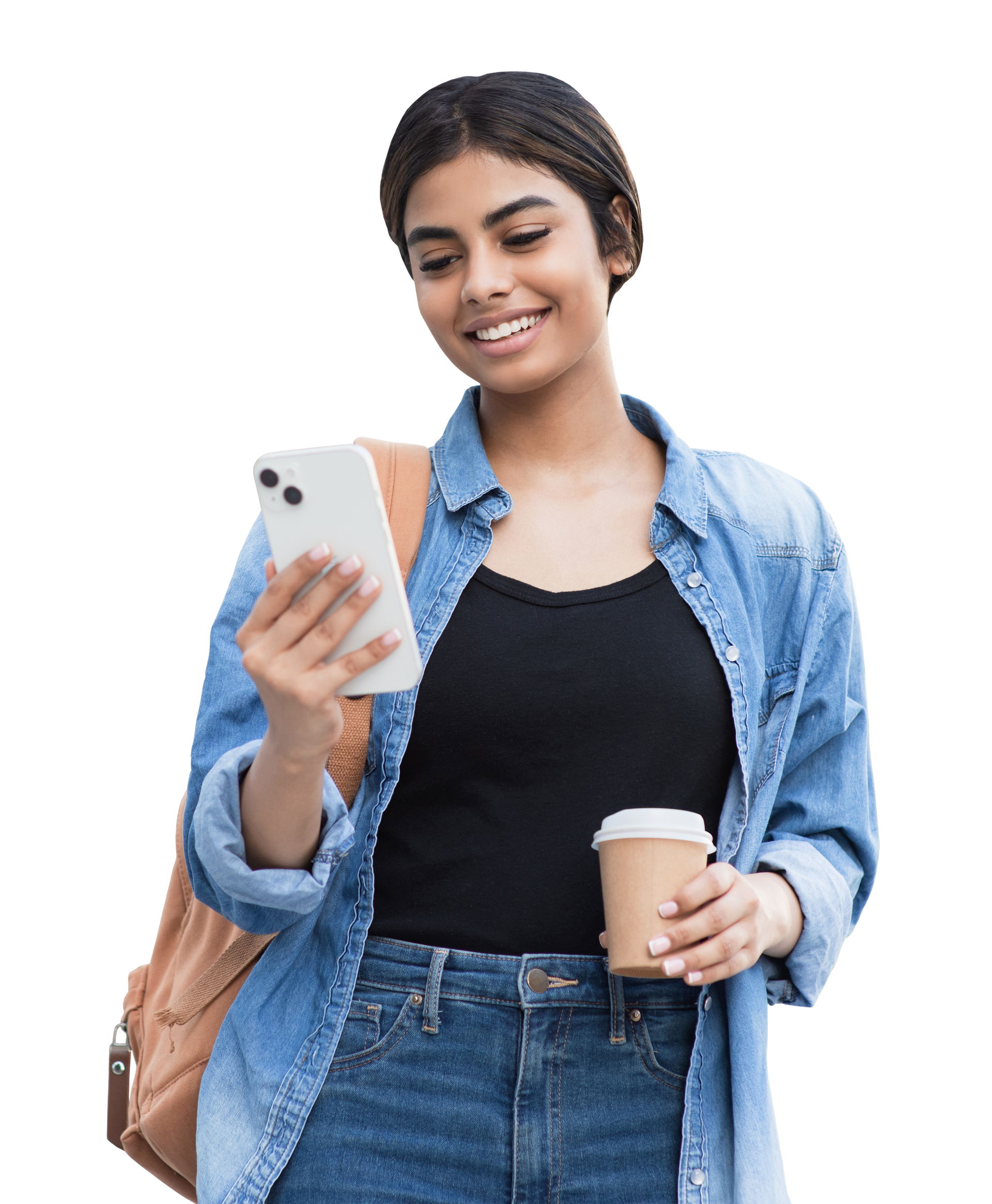 Femme regardant un smartphone, souriante, tenant une tasse de café, portant une veste en jean et un sac à dos.