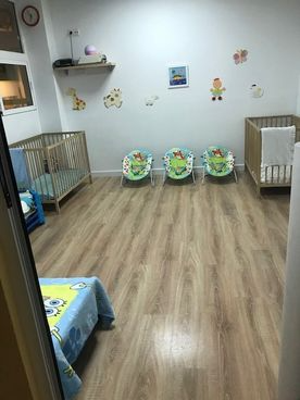 Una habitación con tres cunas y hamacas en ella.