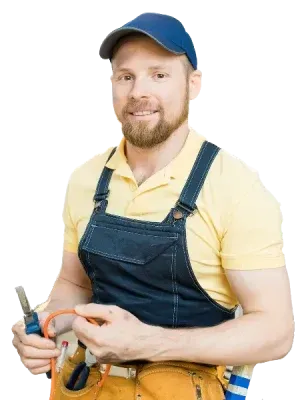 Persona con gorra azul y camisa amarilla sosteniendo herramientas, vestida con un mono de mezclilla.