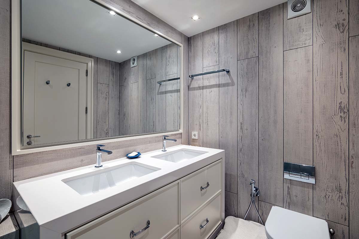 Grand miroir dans une salle de bains au mur de style plancheq de bois brun clair
