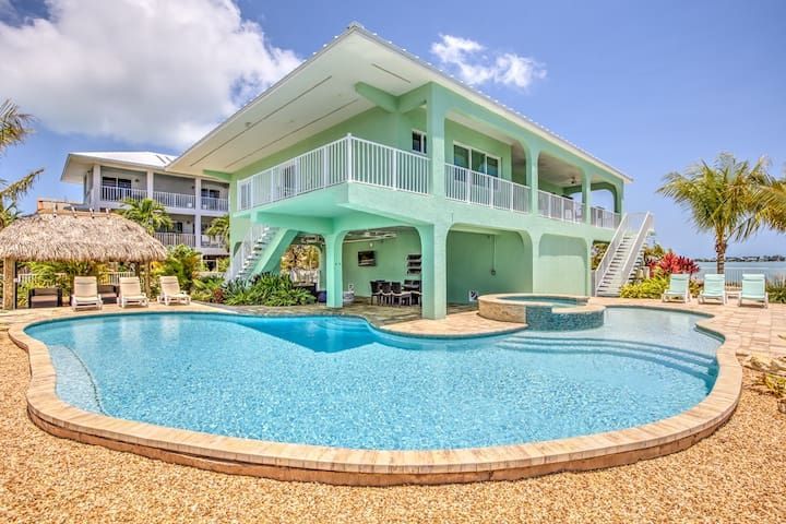 Tropical Marathon Florida Keys vacation rental home with turquoise pool, deck, and ocean view.