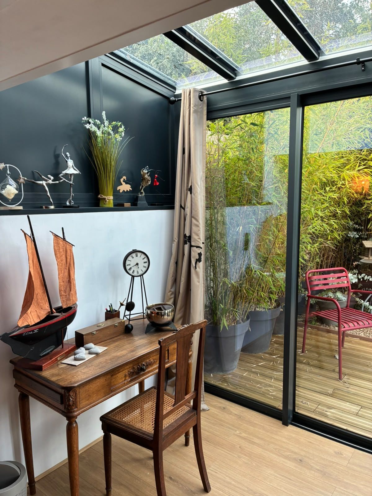 Salon cosy avec un canapé blanc, un miroir orné, une console et une horloge murale.