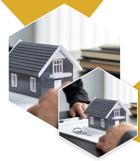 Een persoon met een model van een huis voor een bureau.