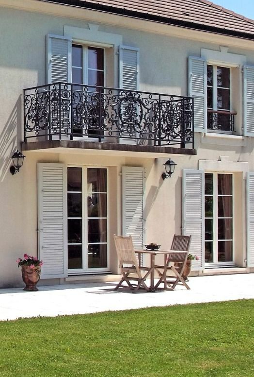 Maison avec des volets persiennes blanc.