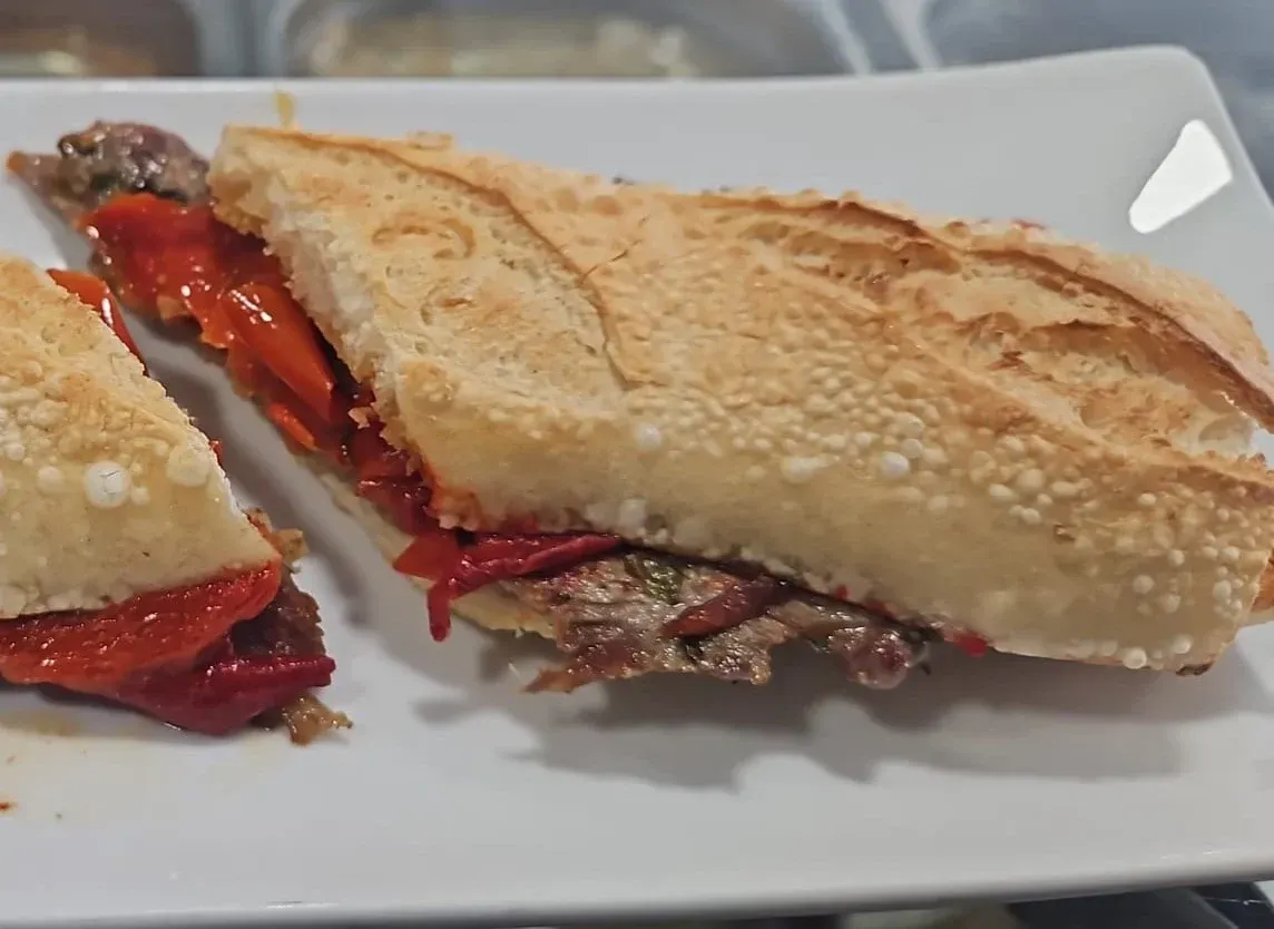Un primer plano de un sándwich en un plato blanco.