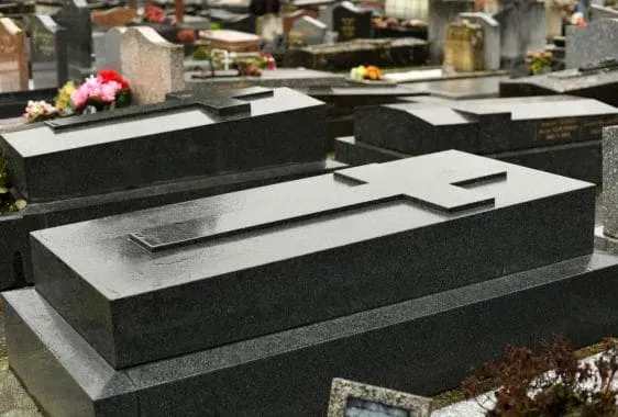 A row of black cabinets are lined up in a room.