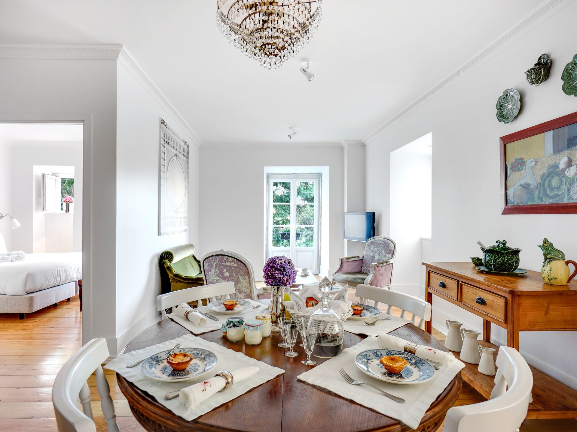 Bright living room with colorful decor and large windows in a  deluxe two-bedroom apartment.