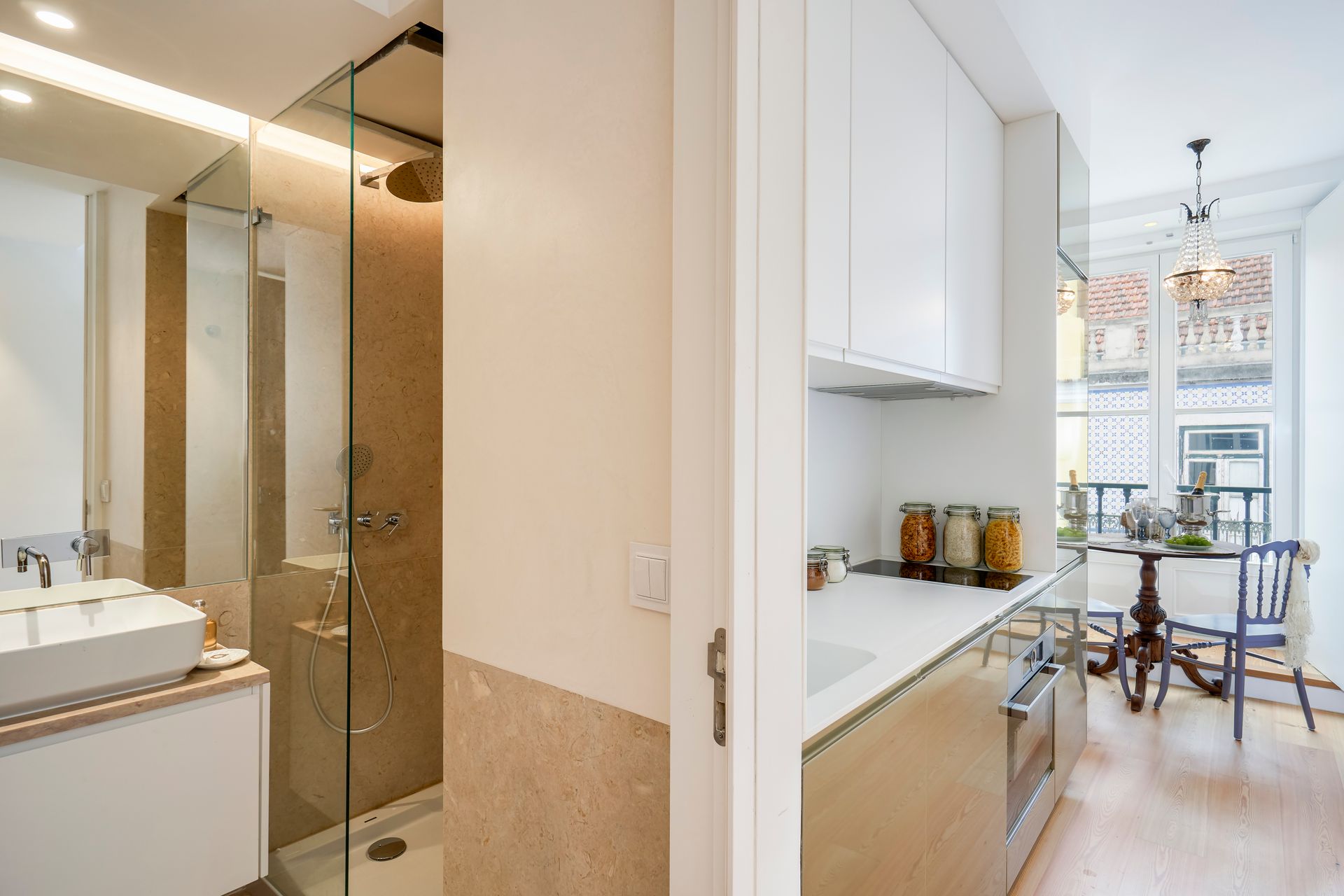 Modern apartment interior with a bathroom and kitchen visible.