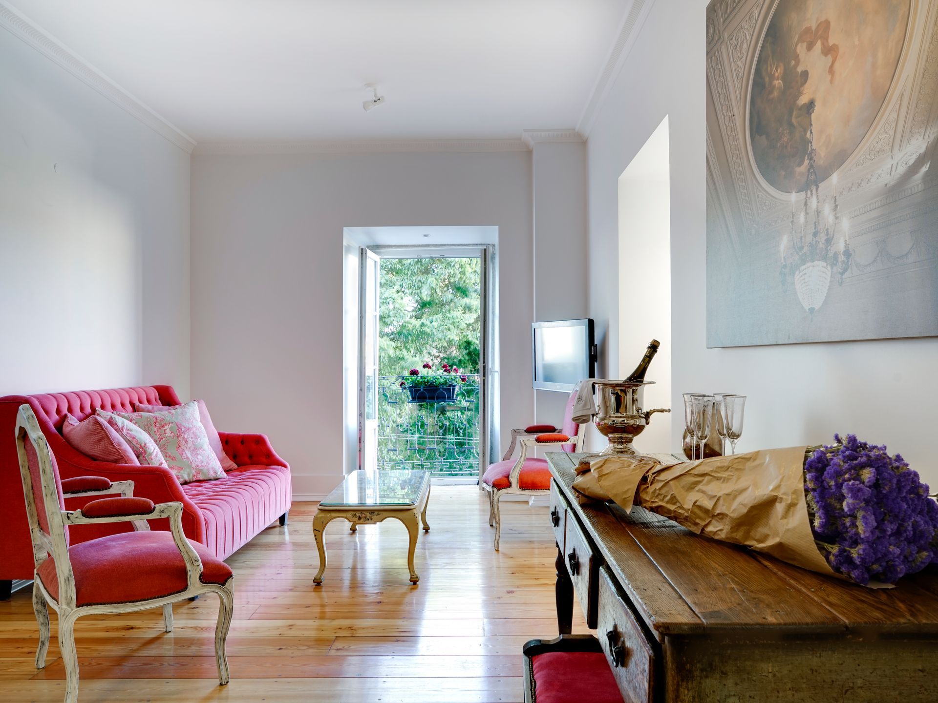 Living room with colorful seating and natural light in a spa deluxe two-bedroom apartment.