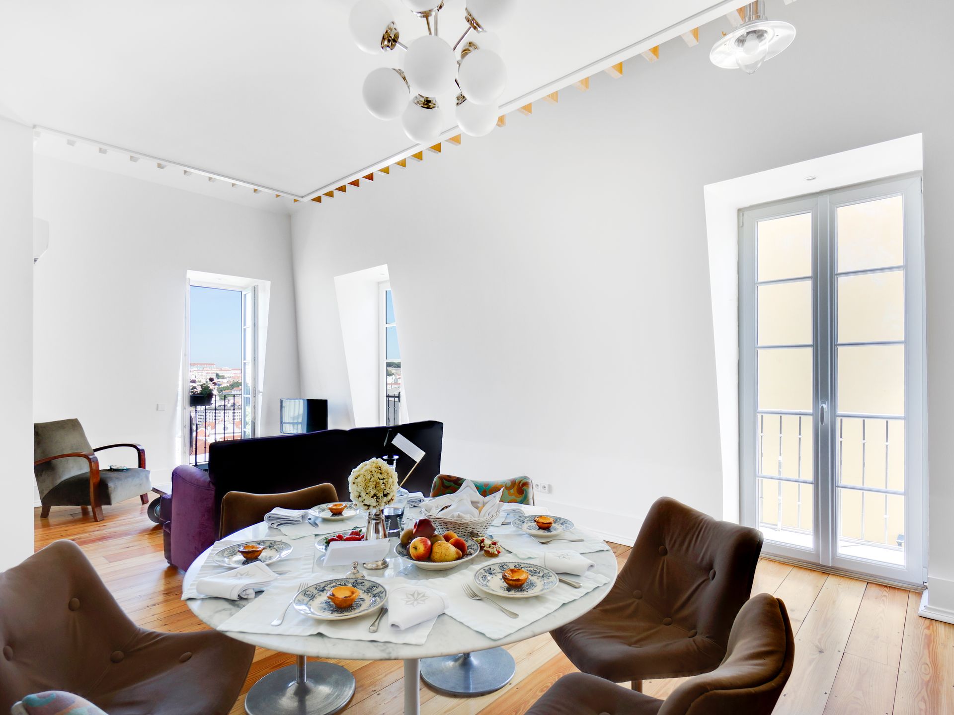 Spacious dining area with natural light and modern decor in a spa penthouse two-bedroom apartment.