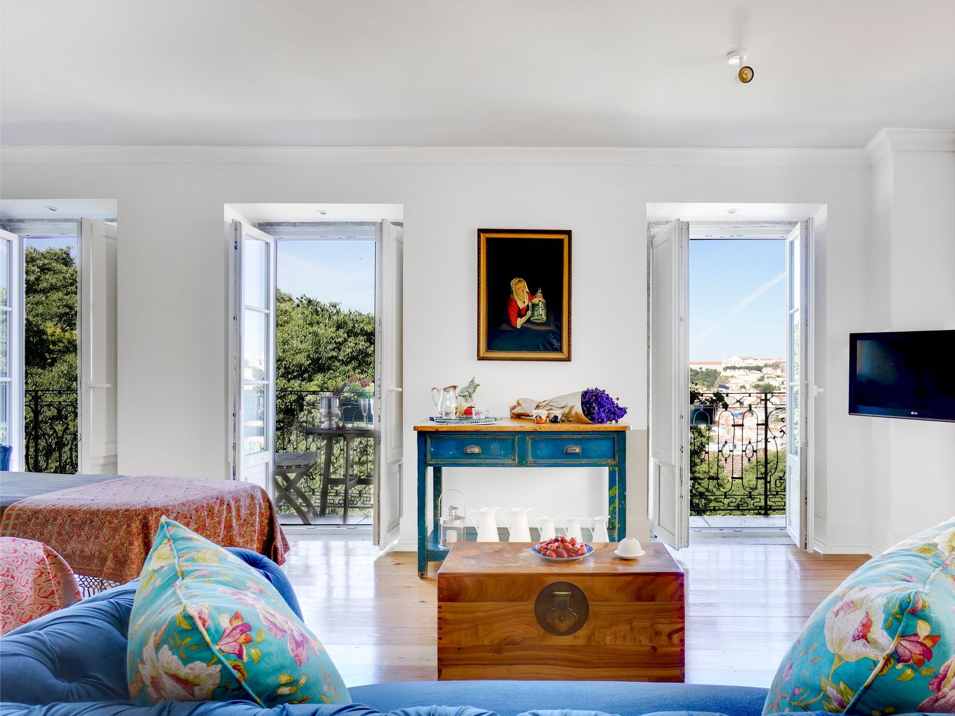 Elegant bedroom in a spa premium one-bedroom apartment with a colorful table and large windows.
