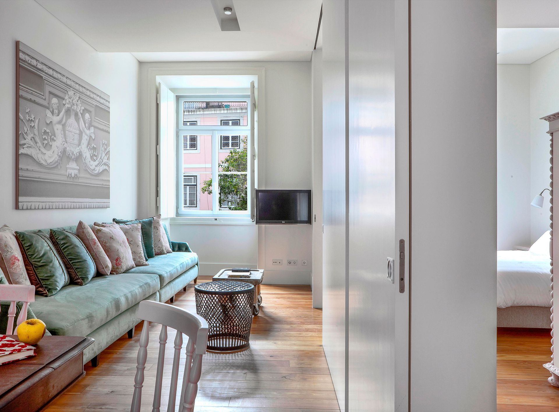 Cozy living area in a deluxe one-bedroom apartment with colorful cushions and natural light.