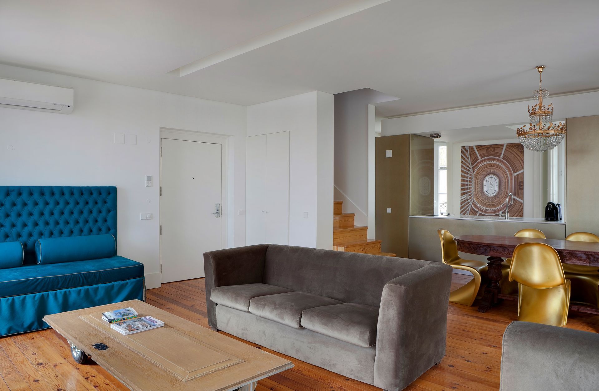 Spacious living room in a duplex two-bedroom apartment with modern decor and comfortable seating.