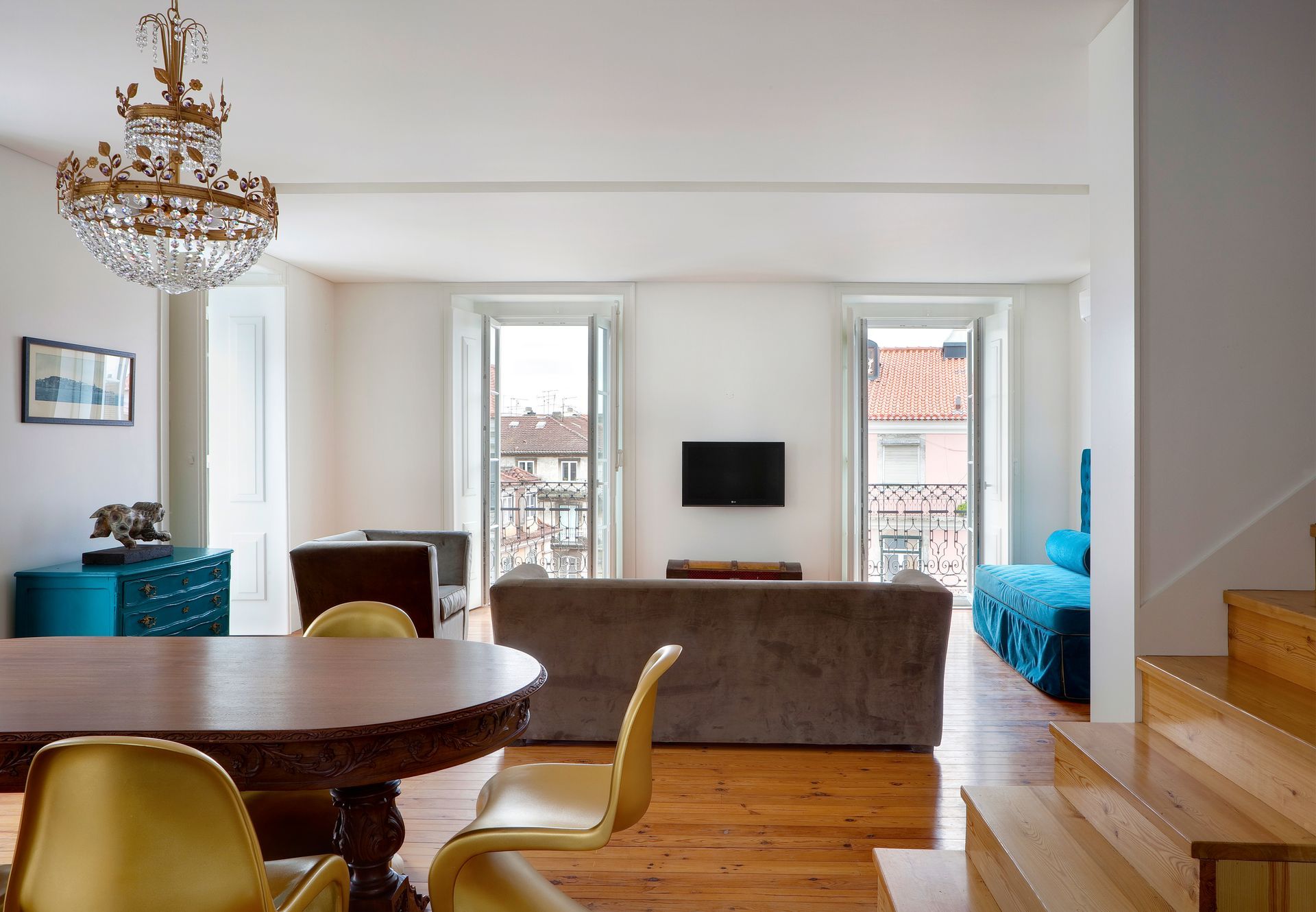 Living area in a duplex two-bedroom apartment with comfortable seating and large windows.