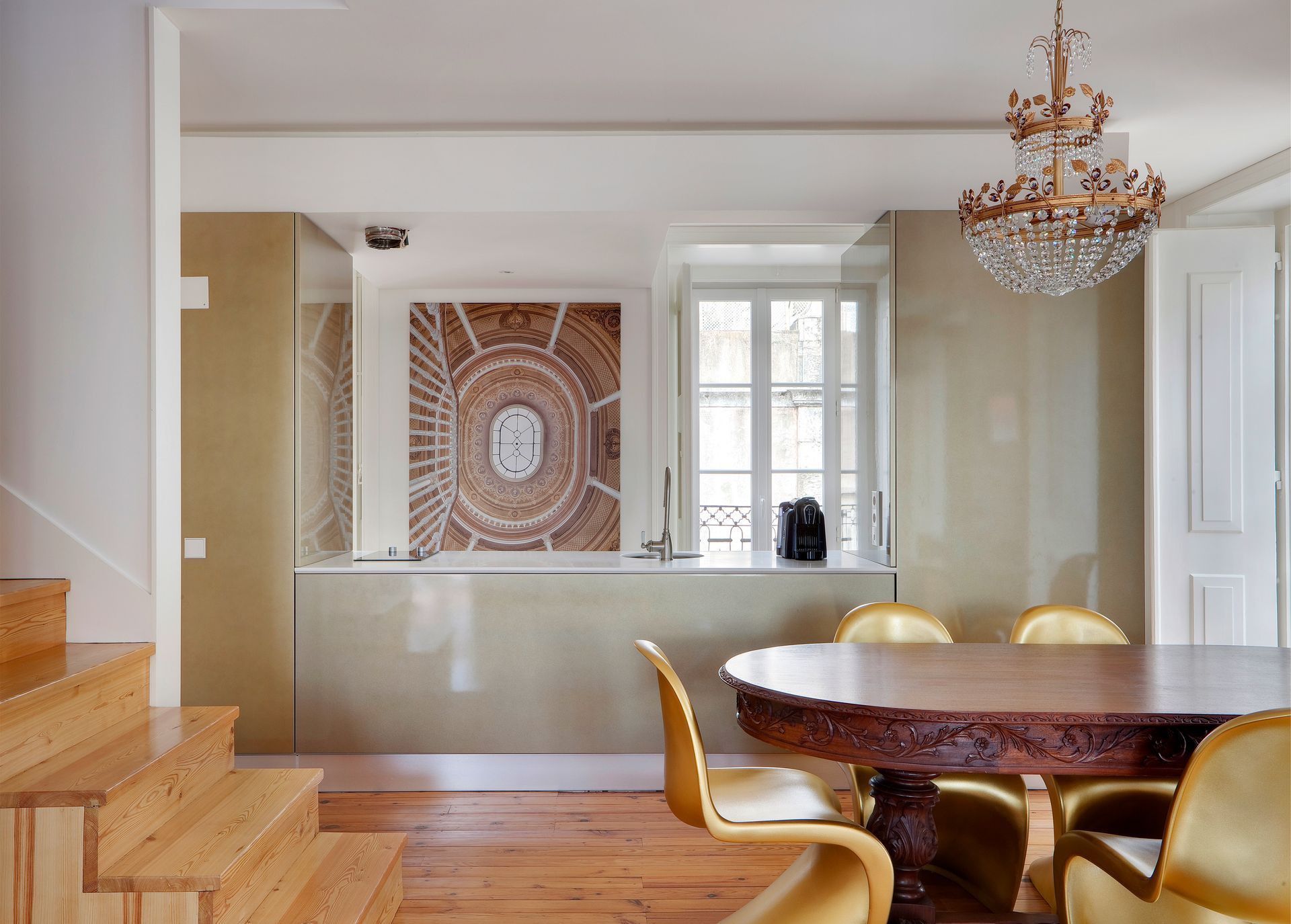 Dining area with a chandelier and large table in a duplex two-bedroom apartment.